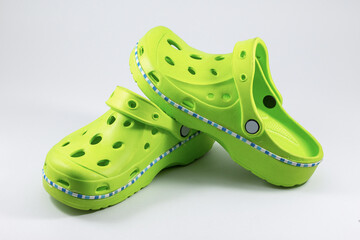 Green rubber sandals on a white background