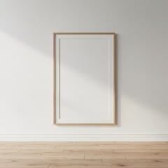 Photo of a black frame mockup hangs on a white wall with a wooden floor, illuminated by natural light