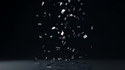 A digitally generated high-resolution video frame of metallic silver confetti falling onto a reflective surface against a black studio background, creating a festive and luxurious celebration concept. - Powered by Adobe