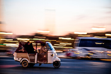 Blurred motion of a motorcycle on a city street at sunset in Paris, France, symbolizing urban mobility, tourism and the fast-paced rhythm of contemporary European city life.