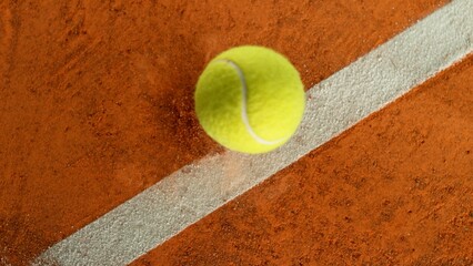Freeze Motion Detail Shot of Tennis Ball Hitting a Clay Court