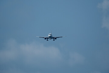 The airplane approaches the airport against a backdrop of clouds. The airplane is ready to land. Airplane in the cloudy sky.