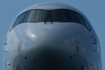 Airplane Nose Close-Up with Cockpit Windows, Close up view of the front of a passenger jet airplane.