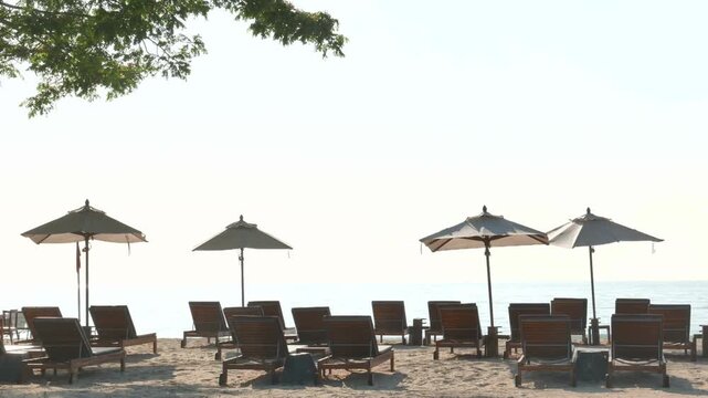 Beach chairs and parasols on a sandy beach by the ocean