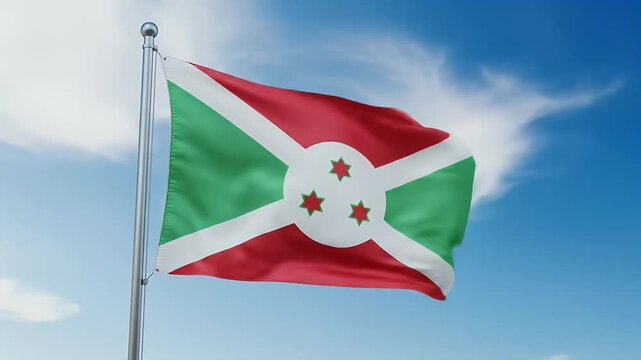 Burundi's national flag billows proudly against a vibrant blue sky, punctuated by fluffy white clouds.