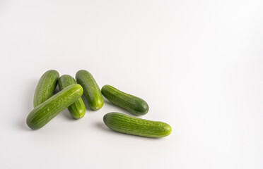 Fresh green cucumbers isolated on white background, crisp, organic, and ready to eat.
