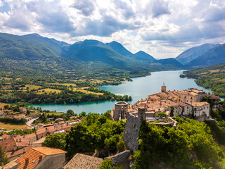 Aerial drone view of the medieval village of Barrea with its magnificent lake in the province of L'Aquila, Abruzzo. This place exudes history, peace, and tranquility.
