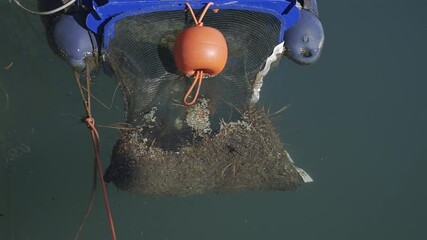 Close up of a floating marine debris collection device in the water