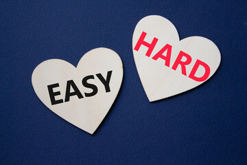 Easy or Hard symbol. Concept word Easy or Hard on wooden hearts. Beautiful deep blue background. Business and Easy or Hard concept. Copy space