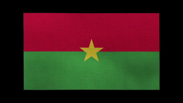 A Burkina Faso flag rolls and waves in front of a black background.
