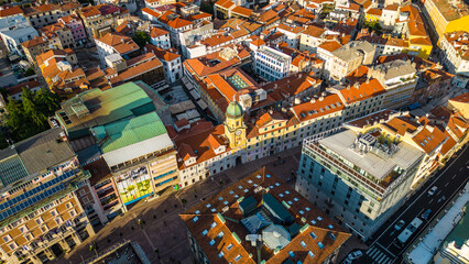 Rijeka city center and waterfront aerial view at sunset, panoramic view of the Kvarner Gulf in Croatia. Scenic harbor with boats, historic architecture, container terminal, canals, seafront promenade
