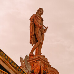 Majestic statue of Apollo, the Greek god of fine arts, standing with a serene expression. Details...