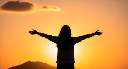 Fototapeta premium Silhouette of a woman with outstretched arms enjoying sunrise or sunset in a scenic outdoor setting symbolizing freedom relaxation and positive energy in nature scene