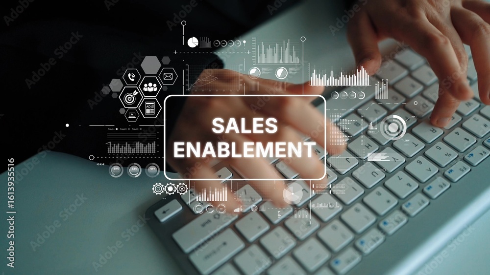 Poster hands on keyboard with digital graphics representing sales enablement concepts in modern business en