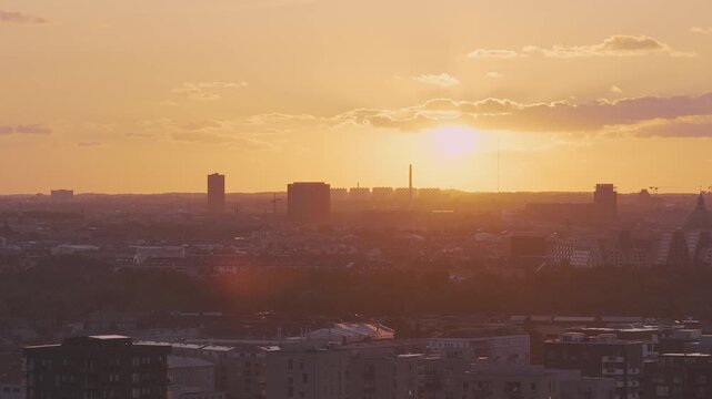 Aerial view of Copenhagen at sunset, featuring Copenhill Power Plant and city skyline. The camera pans across modern and historic architecture.