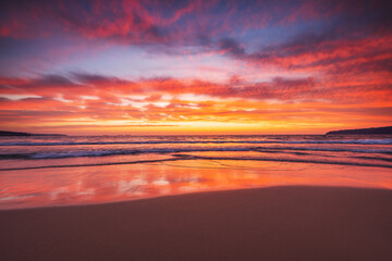 Stunning Beach Sunset With Vibrant Colors and Soothing Waves on the shore