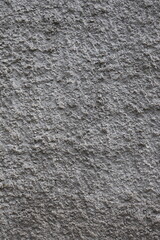 Textured grey wall showcasing rough surface details and natural imperfections in urban setting