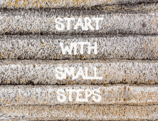 Start with small steps symbol. Concept words phrase Start with small steps on beautiful grey stone wall. Beautiful stone wall background. Business Start with small steps concept. Copy space.