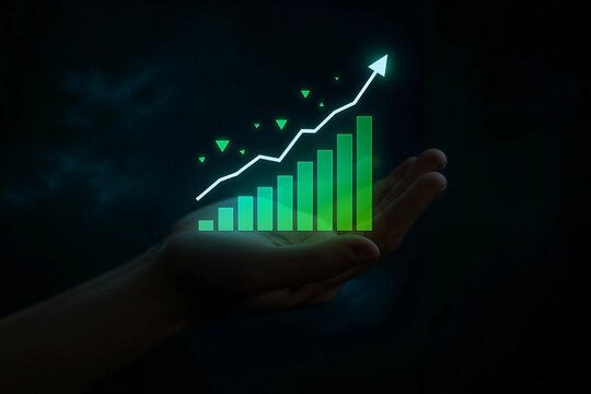 Hand holding a glowing green bar chart symbolizing business growth and financial success on a dark background. - Powered by Adobe