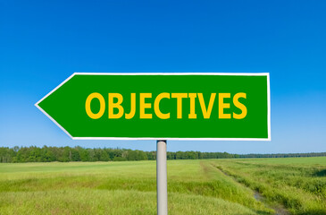 Objectives symbol. Concept word Objectives on beautiful green road sign. Beautiful blue sky green grass and forest peaceful nature background. Business objectives concept. Copy space.