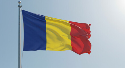 The Romanian national flag fluttering in the early morning wind, isolated against a clear sky.
