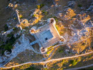 Italy, July 5, 2025: Ruins of Rocca Calascio Castle, an Italian tourist destination and landmark in the Gran Sasso National Park, L'Aquila, Abruzzo. Clear blue skies at sunset.