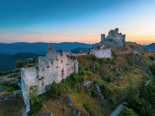 Italy, July 5, 2025: Ruins of Rocca Calascio Castle, an Italian tourist destination and landmark in the Gran Sasso National Park, L'Aquila, Abruzzo. Clear blue skies at sunset.