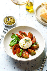 burrata with tomatoes, basil and pesto