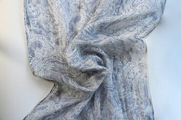 High resolution close up background photo of creased linen blue and white shawl with paisley design