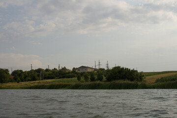 A body of water with trees and grass in the background