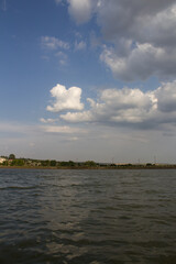 A body of water with clouds in the sky