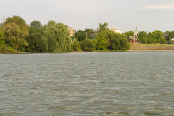 A body of water with trees and buildings in the background