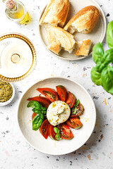 burrata with tomatoes, basil and pesto