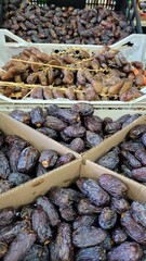 A vertical photograph showing an abundance of dates arranged in several rows and boxes on a counter