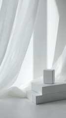 Soft white light streams through sheer curtains, illuminating a stack of white boxes