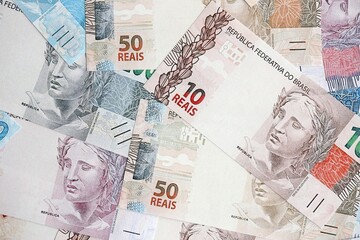 Brazilian reais banknotes. The current Brazil real money bills lies on table in big amount
