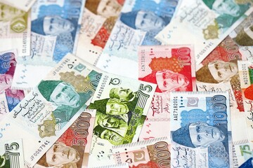 Pakistan rupees banknotes. The current Pakistan money bills lies on table in big amount