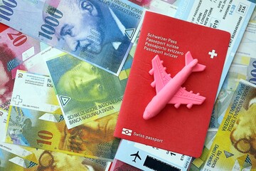Swiss franc banknotes and passport with tickets. The current francs money bills and biometrical pass