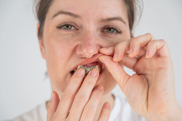 A woman uses chewing tobacco. 