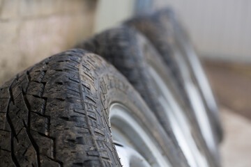 Wheels with old worn-out car tires.