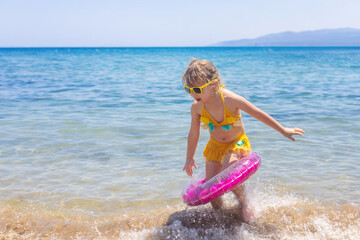 Child with a ring on the sea. Selective focus.