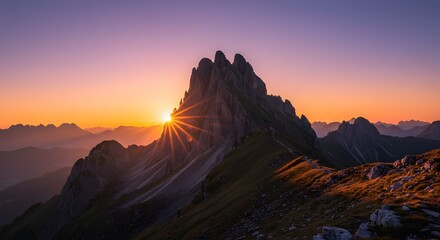 Sunlight hitting a dramatic mountain peak at golden hour