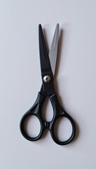 pair of scissors half opened, isolated on white