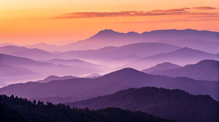 Layers of purple mountains are revealed at a vibrant sunset