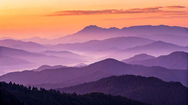 Layers of purple mountains are revealed at a vibrant sunset