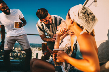Friends enjoying drinks on a rooftop terrace
