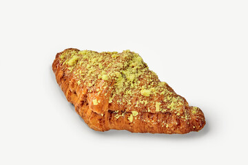 Delicious pistachio croissant isolated on white background