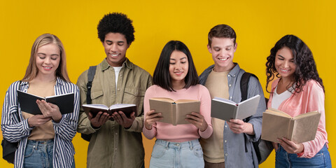 Modern education and teamwork. Happy young university students studying with books in library, group of multiracial people in college read, isolated on orange background, studio shot, empty space