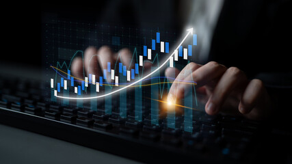 A business professional analyzes financial data using stock market graphs on a computer keyboard in a modern office, reflecting trends and growth strategies. Impute