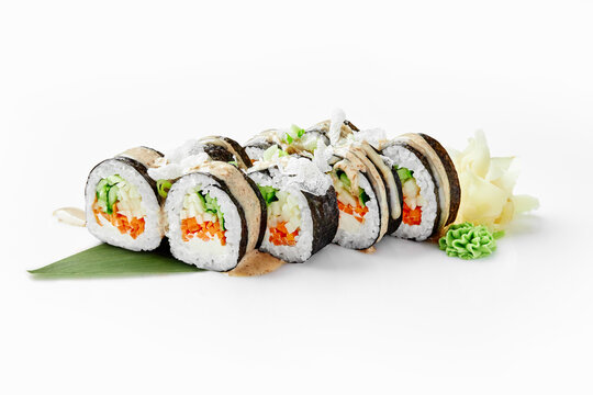 Delicious vegan sushi rolls with vegetables and sesame seeds on white background
